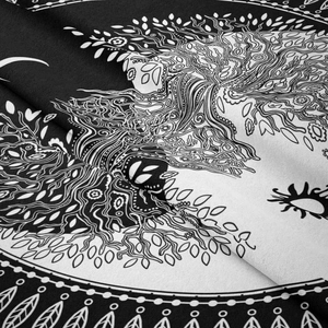Detailed macro view of the intricate tree of life and mandala patterns on black white tapestry