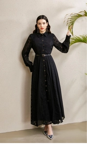 Detail of black lace dress with gold buttons, lapel collar, and waist-cinching belt