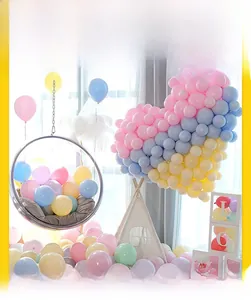 Detail of macaron balloon heart arrangement with LOVE letter boxes for party decor
