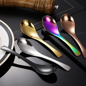 Detail of five stainless steel spoons in silver gold rose gold rainbow and matte black