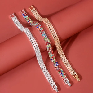 Close-up of sparkling crystal drop bracelets in gold and silver finishes with luxury gems