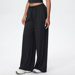 Detail of high waisted black wide leg trousers with elastic drawstring and side pockets