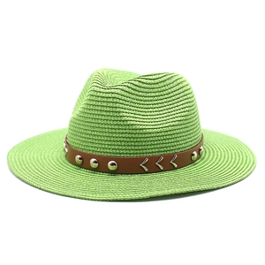 Detail of light green straw hat with brown leather band and silver rivet studs