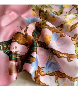 Detail showing the silky texture and elegant oil painting floral print of this pink scarf