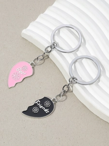 Macro shot of two-piece pink and black heart puzzle keychains with Best Friends lettering
