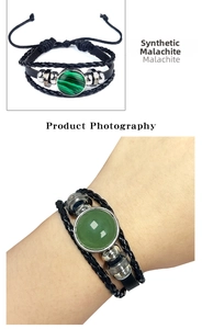 Détail d'un bracelet en cuir tressé multicouche avec malachite verte et perles en métal
