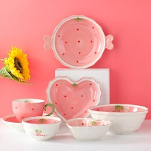 Detailed set of strawberry ceramic tableware including bowls, plates and coffee cup