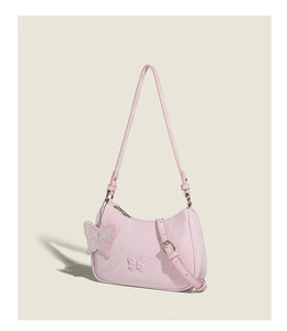 Detail of pink butterfly underarm bag with 3D accents and matching butterfly charm