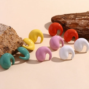 Macro detail of colorful glazed comma-shaped earrings in 18K gold plated stainless steel