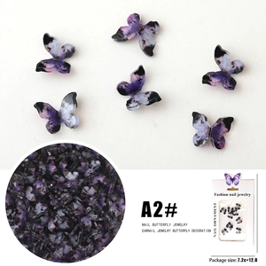 Detailed view of 3D purple resin butterfly nail charms with retail packaging and size chart