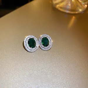 Elegant emerald green oval cubic zirconia earrings with silver-tone double halo design