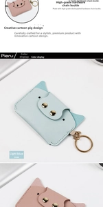 Detail of light blue cartoon pig card holder with premium gold-tone metal keychain