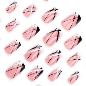 Short square press-on nails with black and white diagonal French pattern on nude base
