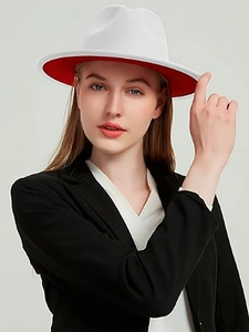 Detail of white fedora with red underbrim worn with a black tailored blazer jacket