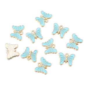 Detailed view of ten blue enamel butterfly pendants with golden alloy frames on white