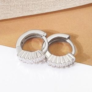 Silver S925 earrings featuring sparkling rectangular cubic zirconia on a warm background