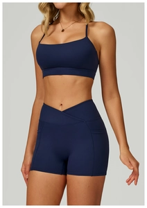 Detail of navy blue cross-waist yoga shorts with side pockets and smooth athletic fabric