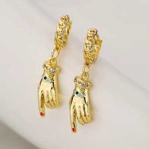 Gold-plated hoop earrings with evil eye palm pendants and red nail details with zircons