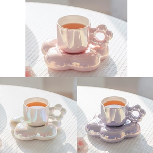 Detailed view of floral ceramic coffee cups in pearl pink, white, and purple finishes