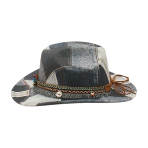 Detail of vintage patchwork denim cowboy hat with ethnic beads and tassel trim