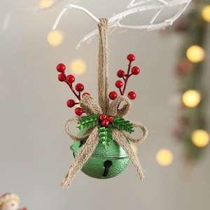 Close-up of green Christmas bell with red berries and brown jute bow hanging on branch
