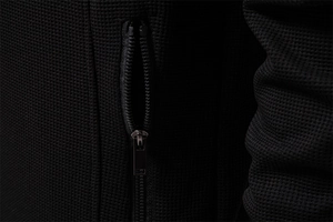 Detail of waffle-knit fabric and premium metal zipper on a men's stand-collar jacket