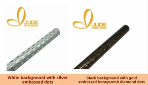 Detail of white silver dot and black gold honeycomb gift wrapping paper rolls