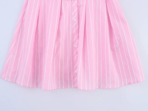 Detailed macro view of pink and white vertical stripes fabric with white button closure