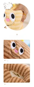 Close-up of the soft plush fabric and cute embroidered cartoon facial features on the hand warmer