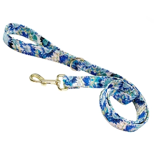 Floral dog leash with blue and white pattern and gold metal hook on white background
