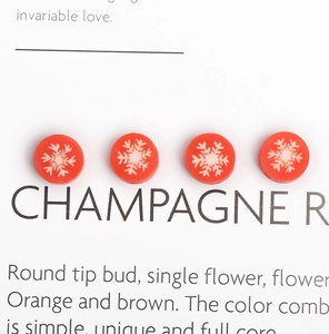 Macro view of red polymer clay beads with white snowflake patterns for DIY jewelry making