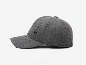 Side view of dark gray winter baseball cap showing thick fabric and metal logo badge
