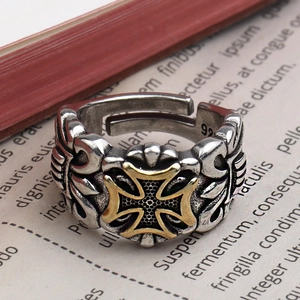 Retro two-tone cross ring with 925 silver stamp on a vintage book background