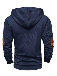 Detail view of navy blue hoodie with diamond texture and brown elbow patches on back
