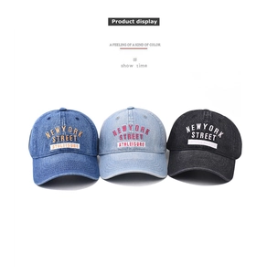 Detailed embroidery on vintage washed denim baseball caps in blue and black colors