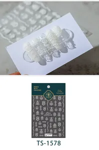 Macro detail of white floral wave lace nail stickers showing 3D embossed texture
