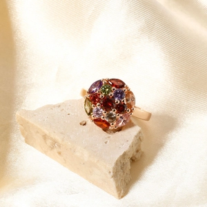 Classic rose gold ring with a colorful cluster of zircon stones on a silk backdrop
