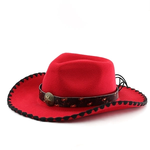 Detail of red cowboy hat with vintage star badge and black stitched edge