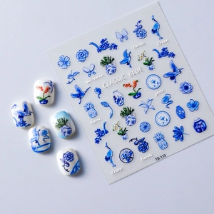 Macro view of 5D blue and white porcelain nail stickers with cranes and floral patterns