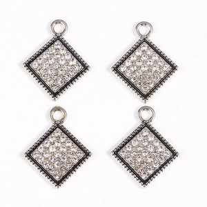 Close-up of four silver diamond square pendants for DIY jewelry and earrings