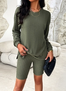 Detail of dark green ribbed knit long sleeve top and high waist shorts leisure set