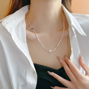 Detail of silver smiley face pendants on a dainty sterling silver collar necklace