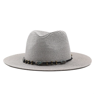 Grey woven straw fedora hat with turquoise bead band decoration on white background