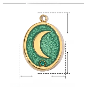 Detail of oval moon pendant size 17mm by 12mm with green enamel and gold finish