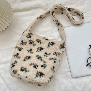 Close-up of floral sherpa fleece bucket bag with soft texture and autumn flower patterns