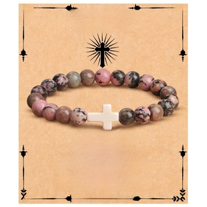 Detail of pink and grey stone beaded bracelet with a white cross on a baptism gift card