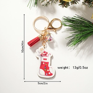Christmas stocking keychain with tassel and sequin glass ball on festive pine branch