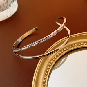 Detailed view of S925 sterling silver stamp on minimalist double-layer zircon cuff