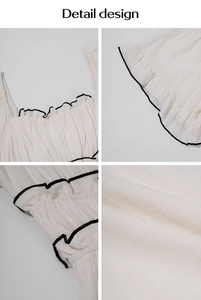 Macro details of white dress featuring black contrast piping, square neck and ruffle texture