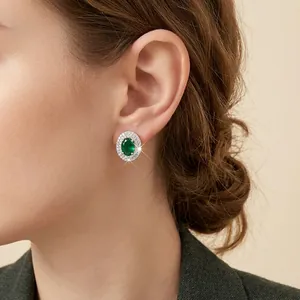 Elegant emerald zircon stud earrings with silver plating shown on a female model
